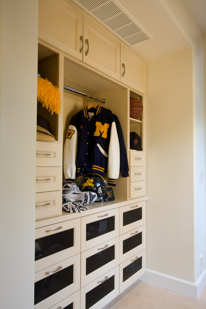 Mid-sized transitional storage and wardrobe in San Francisco with limestone floors and beige cabinets.