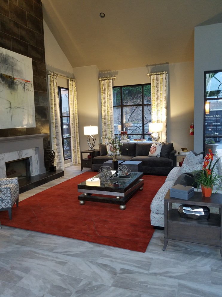 Inspiration for a large asian open concept living room in Atlanta with grey walls, porcelain floors, a standard fireplace, a tile fireplace surround, a wall-mounted tv and grey floor.