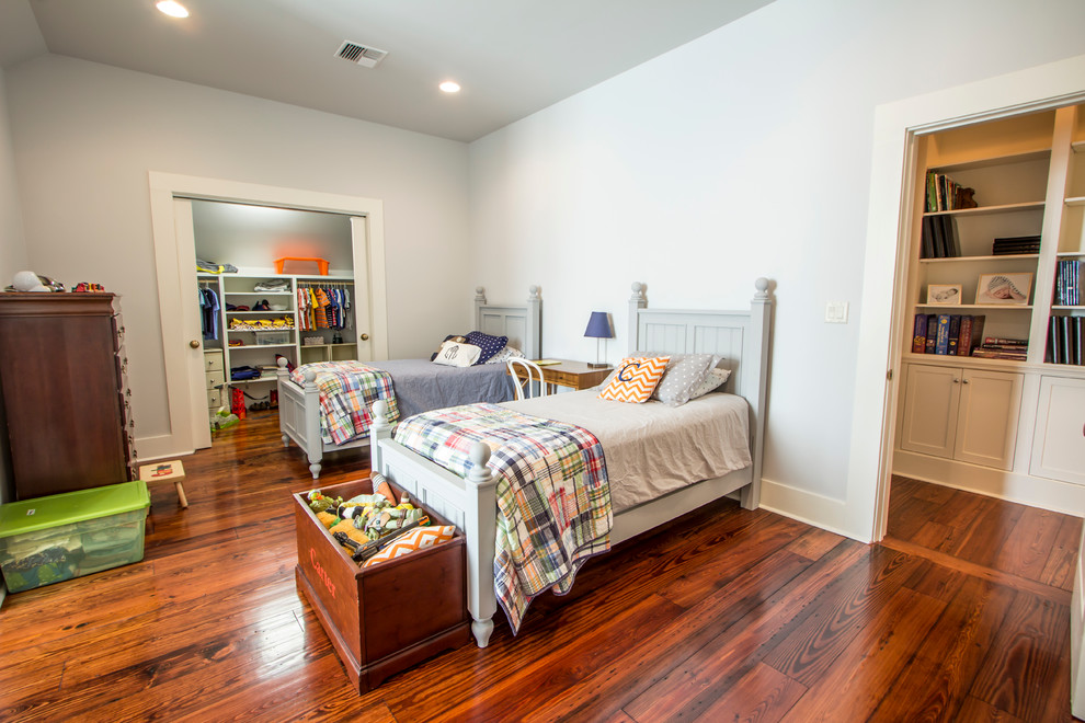 Photo of a large traditional kids' bedroom for kids 4-10 years old and boys in New Orleans with white walls and medium hardwood floors.
