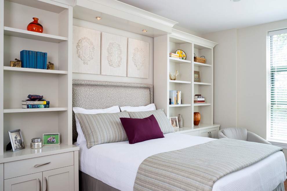 This is an example of a mid-sized transitional guest bedroom in DC Metro with beige walls and medium hardwood floors.