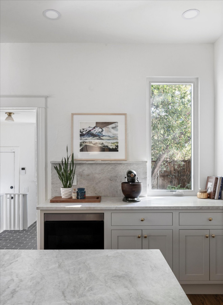 Eat-in kitchen - mid-sized transitional medium tone wood floor and brown floor eat-in kitchen idea in Denver with white walls and a standard fireplace