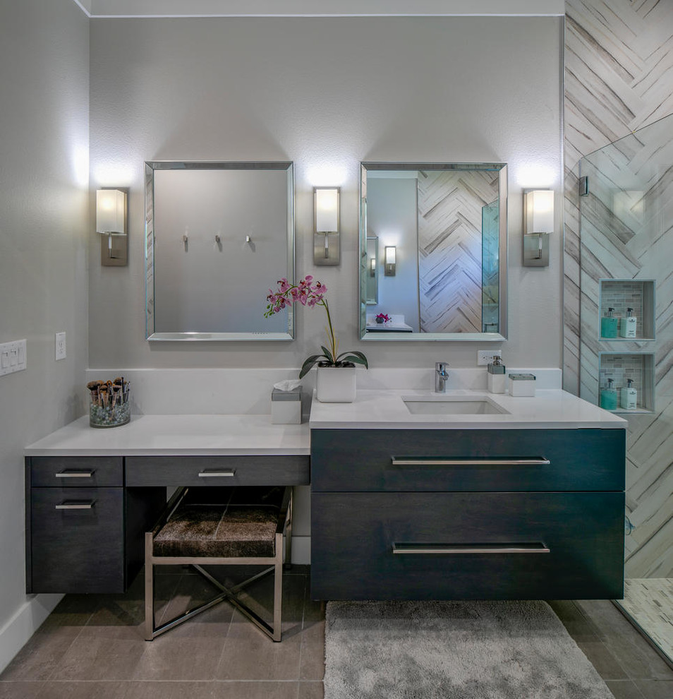 This is an example of a large modern master bathroom in Tampa with flat-panel cabinets, dark wood cabinets, a freestanding tub, an open shower, a one-piece toilet, gray tile, porcelain tile, white walls, medium hardwood floors, an undermount sink, engineered quartz benchtops, grey floor and white benchtops.