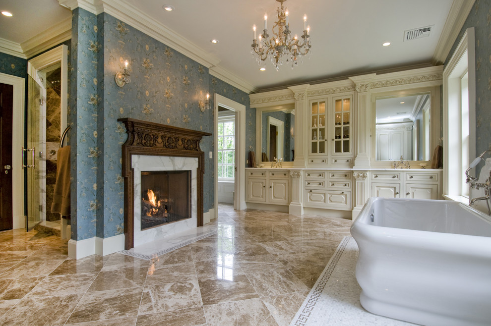 Inspiration for an expansive traditional master bathroom in Newark with a freestanding tub, beige cabinets, an alcove shower, blue walls, marble floors, an undermount sink, marble benchtops, beige floor, a hinged shower door and raised-panel cabinets.