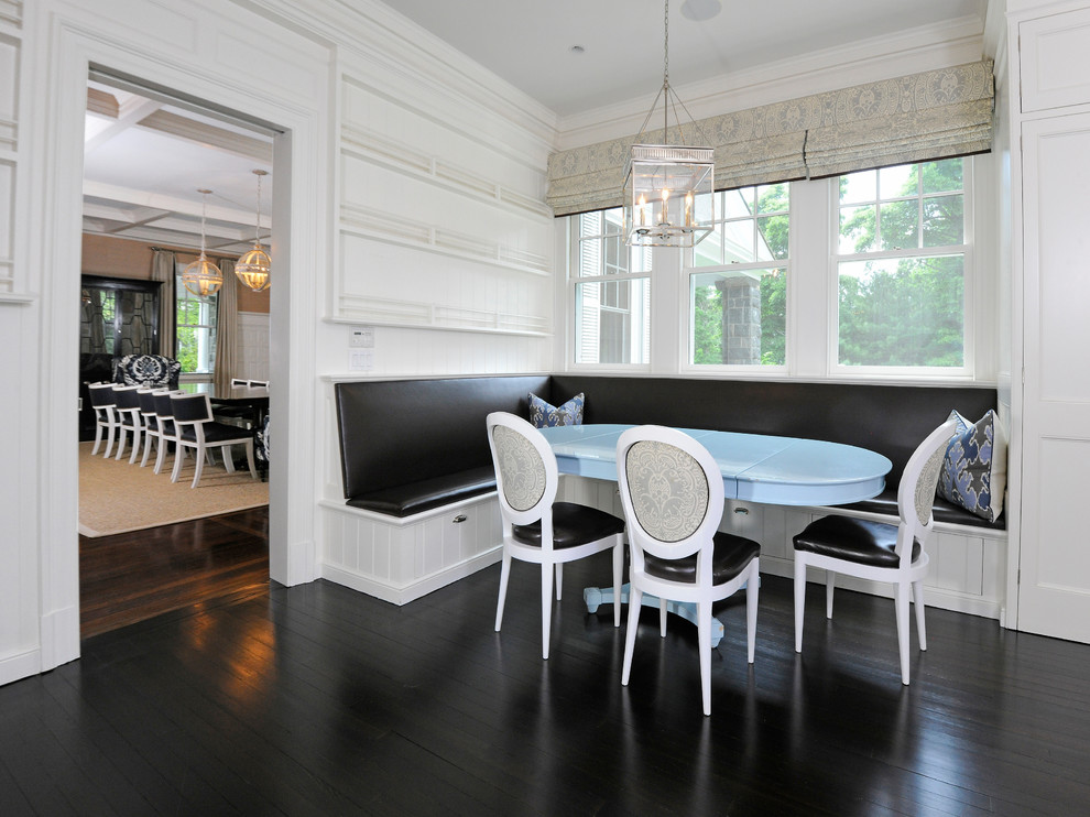 Design ideas for a traditional dining room in New York with white walls, dark hardwood floors and brown floor.