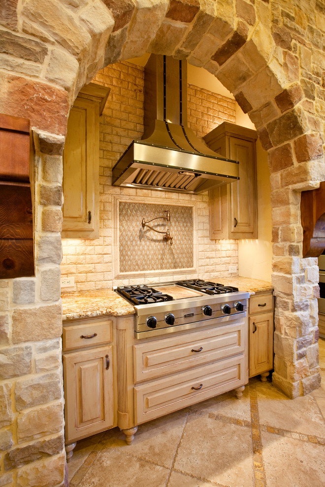 Inspiration for a mediterranean kitchen in Dallas with beige cabinets.