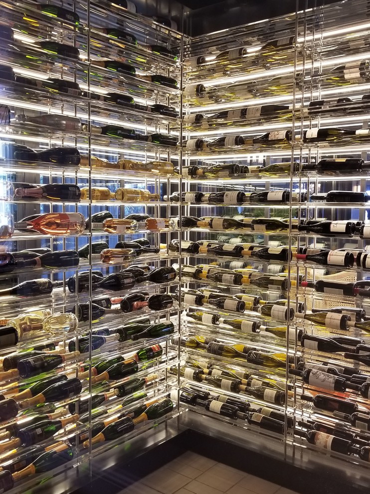 Large beach style wine cellar in Los Angeles with storage racks.