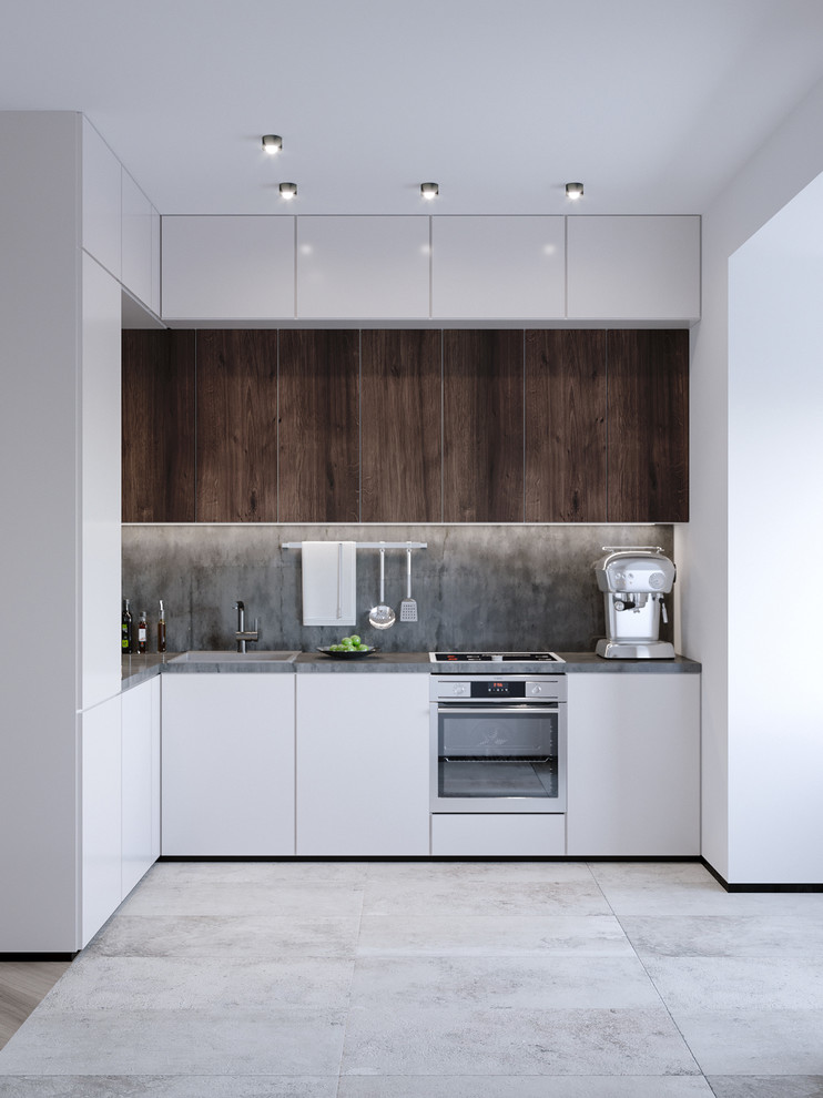 Design ideas for a small modern l-shaped eat-in kitchen in Frankfurt with a single-bowl sink, flat-panel cabinets, white cabinets, quartzite benchtops, grey splashback, cement tile splashback, ceramic floors, no island, grey floor, stainless steel appliances and grey benchtop.