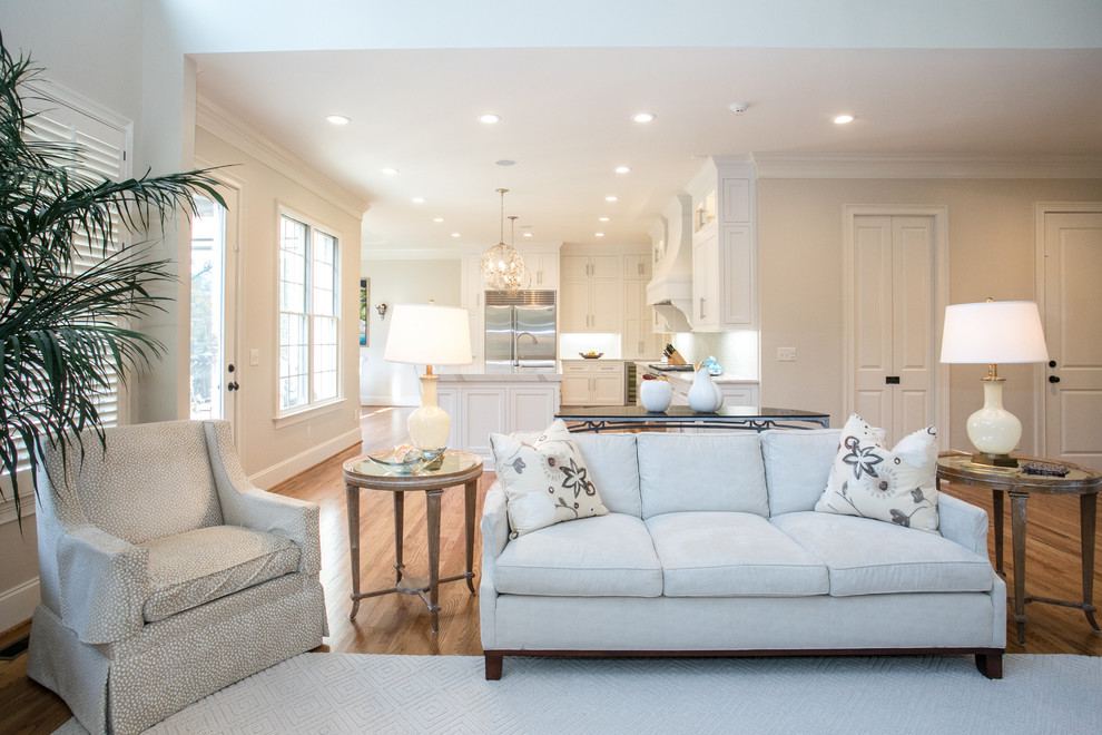 Eat-in kitchen - light wood floor eat-in kitchen idea with a double-bowl sink, beaded inset cabinets, white cabinets, quartz countertops, stainless steel appliances, an island and white countertops
