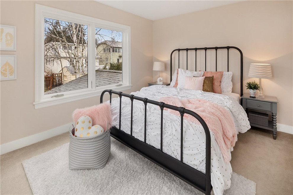 This is an example of a mid-sized transitional kids' room for girls in Seattle with beige walls, carpet and beige floor.