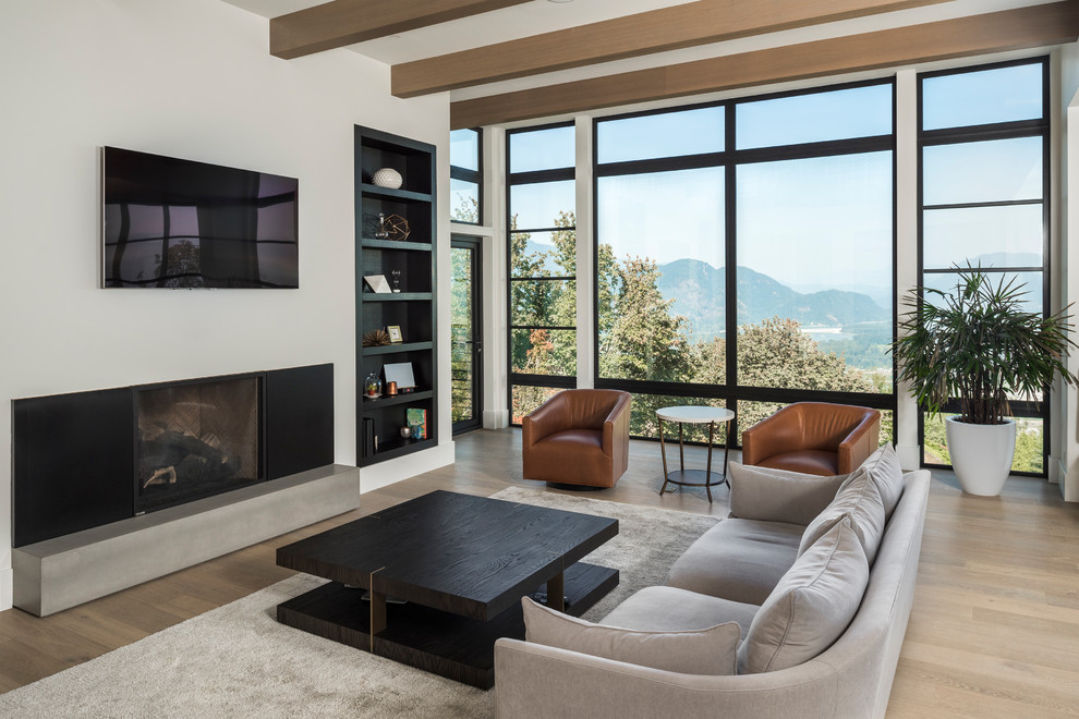 Large contemporary open concept family room in Vancouver with white walls, light hardwood floors, a wall-mounted tv and a ribbon fireplace.