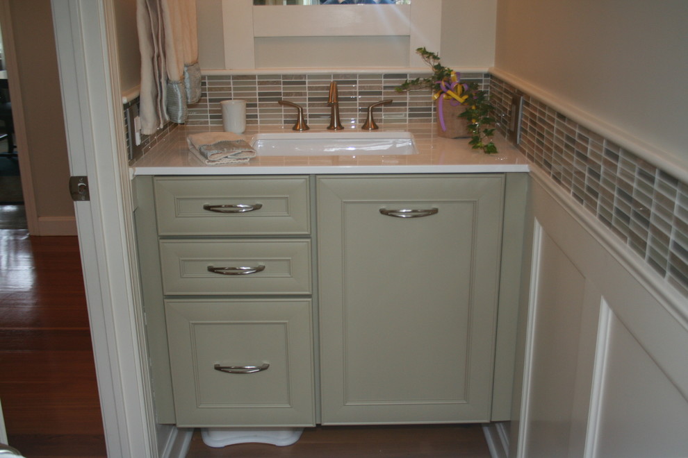 This is an example of a small transitional 3/4 bathroom in Providence with an undermount sink, open cabinets, green cabinets, marble benchtops, a two-piece toilet, green tile, mosaic tile, green walls and light hardwood floors.