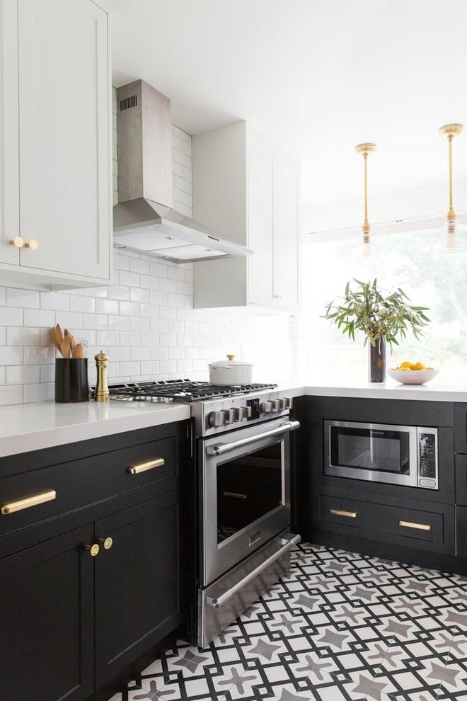 Design ideas for a mid-sized transitional l-shaped separate kitchen in Salt Lake City with a drop-in sink, white cabinets, white splashback, subway tile splashback, stainless steel appliances, cement tiles and multi-coloured floor.