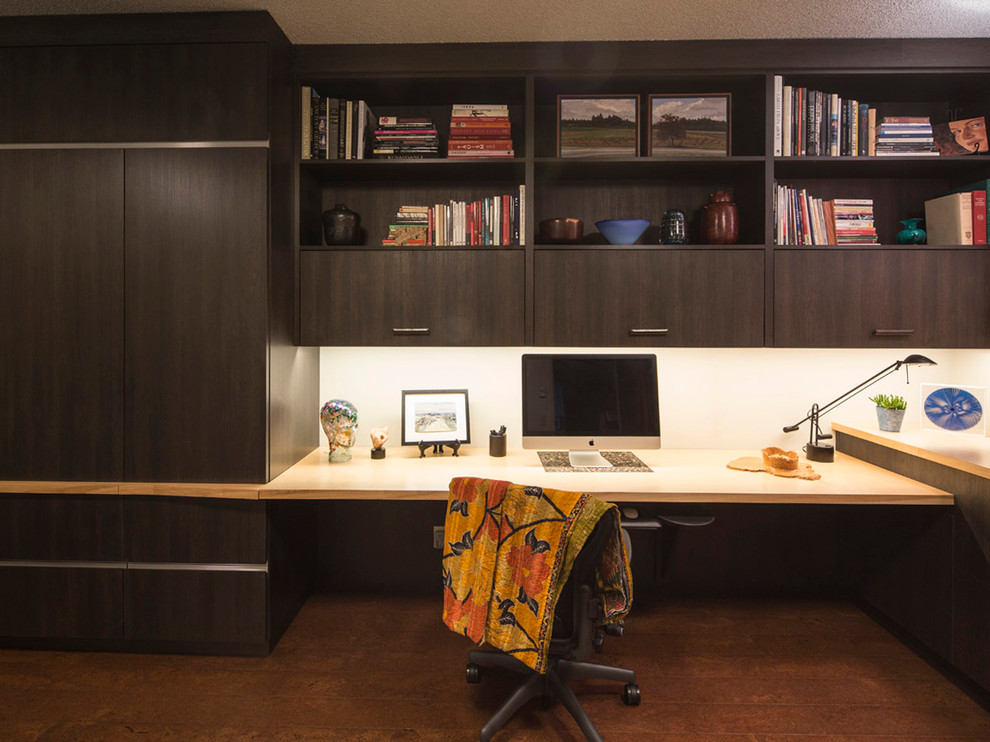 Photo of a small contemporary home office in Portland with cork floors and a built-in desk.