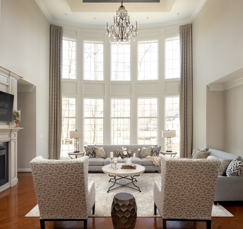 Inspiration for a transitional open concept family room in DC Metro with grey walls, medium hardwood floors, a standard fireplace, a metal fireplace surround, a wall-mounted tv and brown floor.