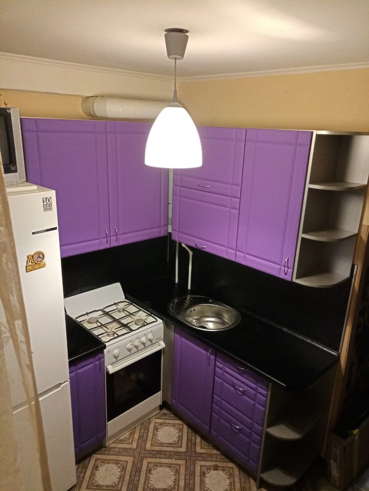 Small contemporary l-shaped separate kitchen in Saint Petersburg with an undermount sink, recessed-panel cabinets, purple cabinets, laminate benchtops, black splashback, timber splashback, white appliances, laminate floors, no island, brown floor and black benchtop.