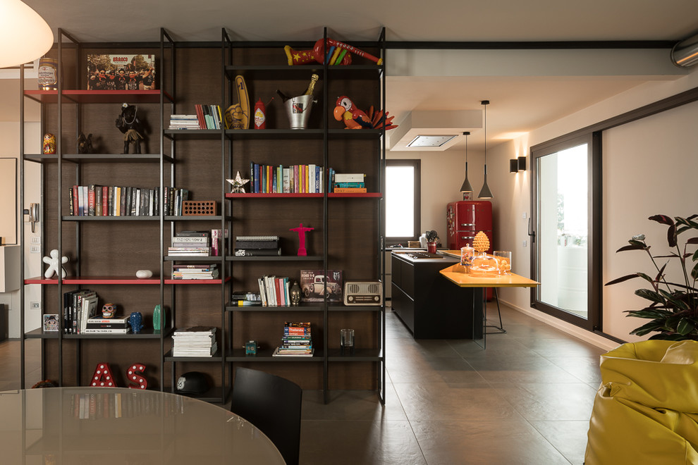 Mid-sized contemporary open plan dining in Bologna with white walls and grey floor.
