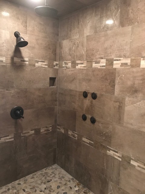 Inspiration for a transitional brown tile and marble tile corner shower remodel in Denver
