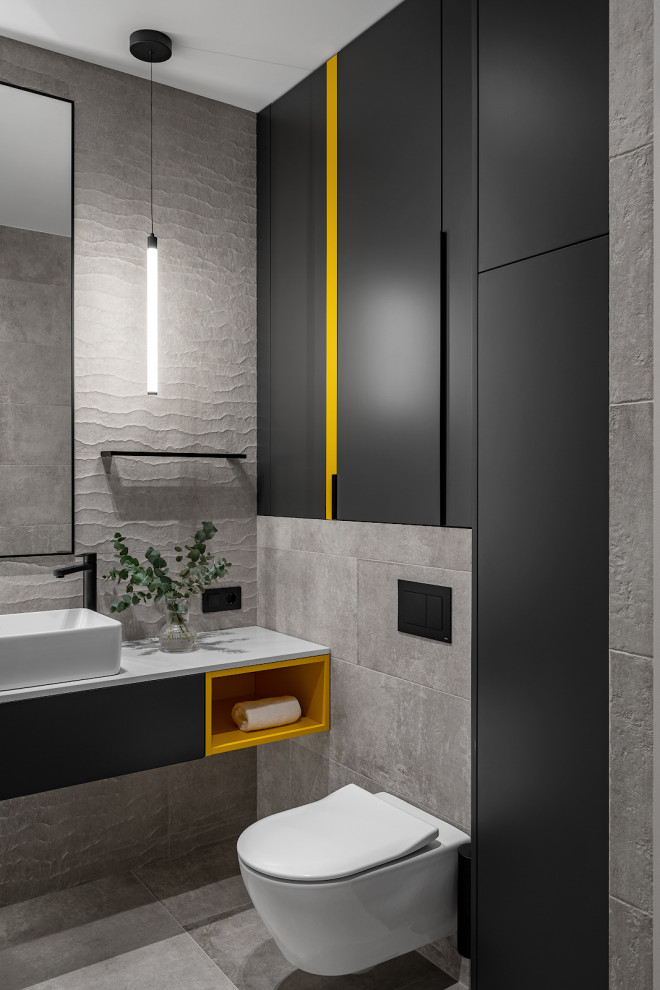 Design ideas for a small contemporary grey and white ensuite bathroom in Moscow with flat-panel cabinets, black cabinets, a submerged bath, a wall mounted toilet, beige tiles, ceramic tiles, beige walls, porcelain flooring, a vessel sink, engineered stone worktops, beige floors, grey worktops, a single sink and a floating vanity unit.
