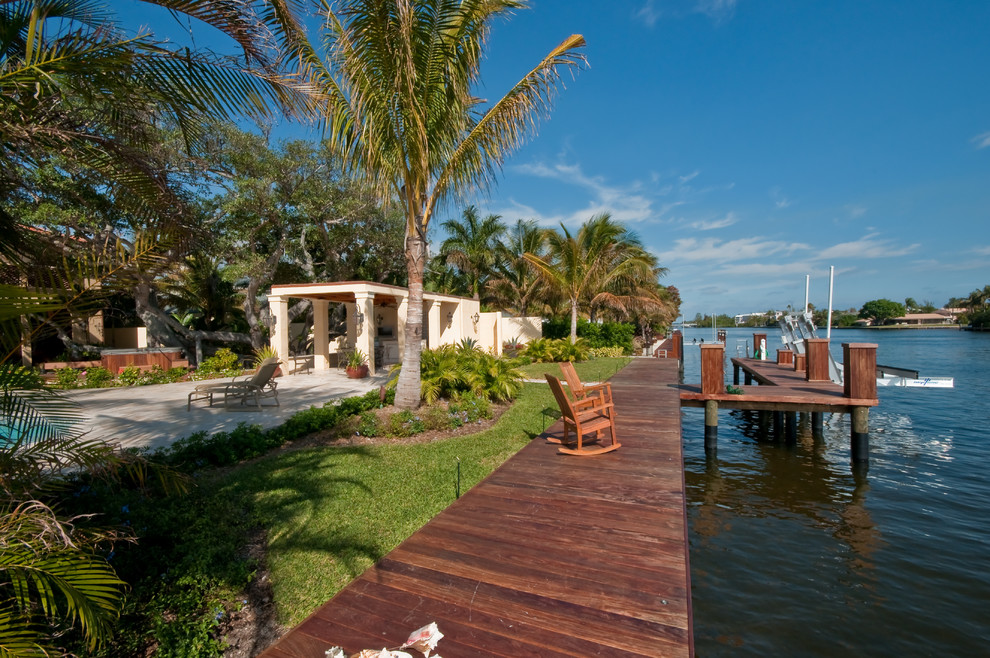 Design ideas for a large mediterranean backyard deck in Miami with no cover.