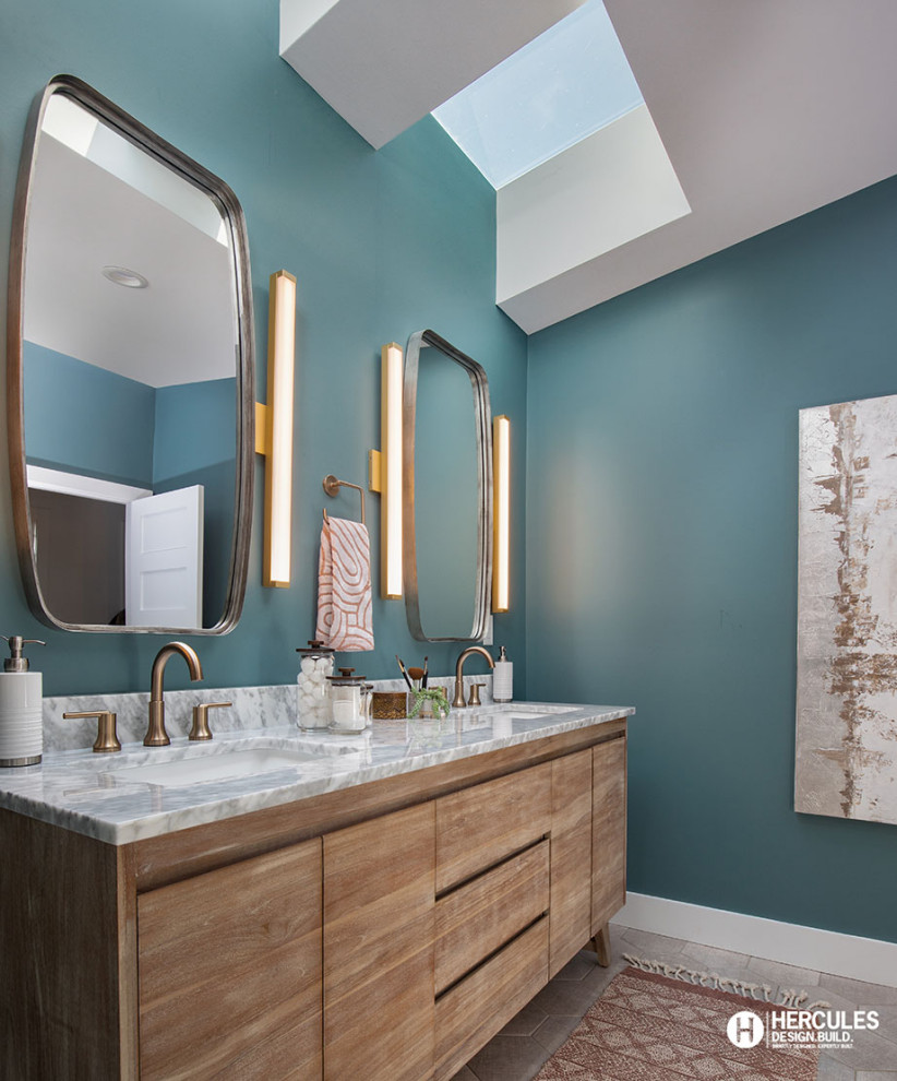 Photo of a mid-sized midcentury master bathroom in St Louis with flat-panel cabinets, medium wood cabinets, a two-piece toilet, white walls, medium hardwood floors, an undermount sink, marble benchtops, grey floor, grey benchtops, a double vanity, a freestanding vanity and vaulted.