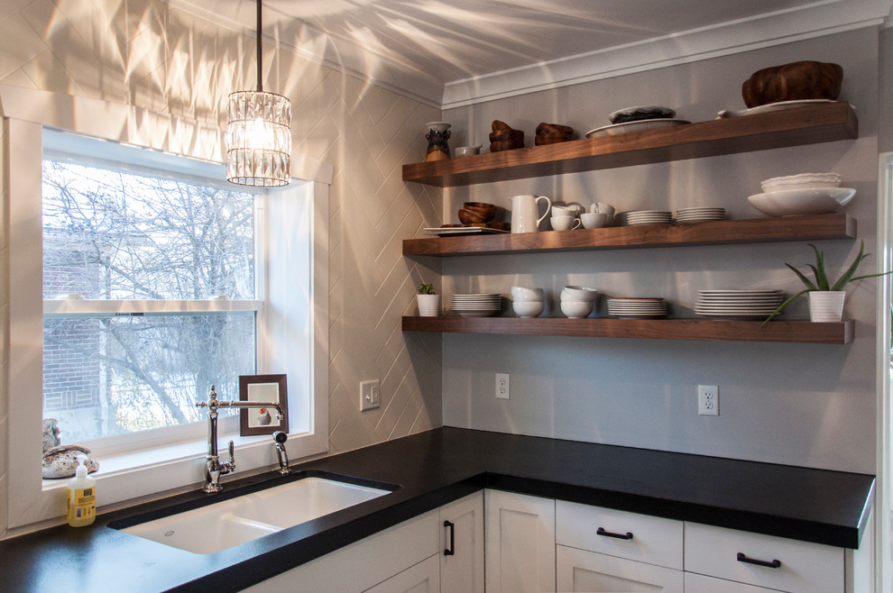 Inspiration for a mid-sized arts and crafts galley eat-in kitchen in Salt Lake City with an undermount sink, shaker cabinets, white cabinets, granite benchtops, white splashback, subway tile splashback, stainless steel appliances, porcelain floors, no island and grey floor.