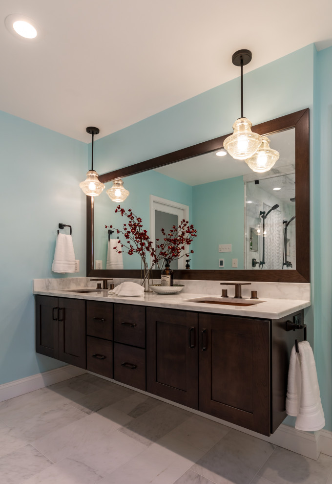 Photo of a small contemporary master bathroom in DC Metro with dark wood cabinets, a freestanding tub, a double shower, a one-piece toilet, blue walls, marble floors, marble benchtops, grey floor, a hinged shower door, white benchtops, a shower seat, a double vanity and a floating vanity.