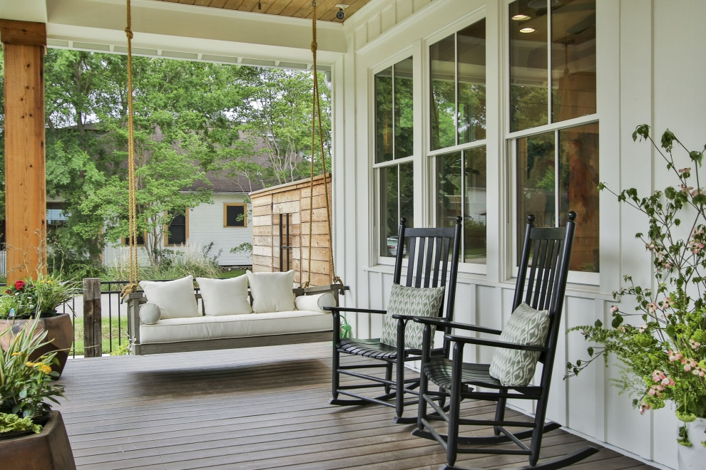 This is an example of a cottage porch design in Houston with decking and a roof extension.