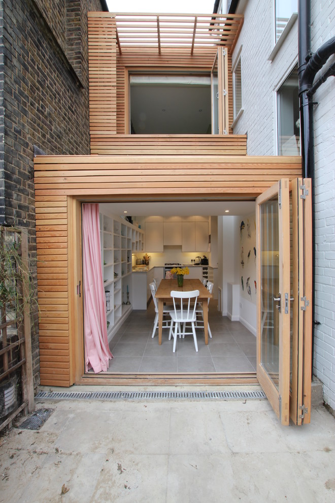 This is an example of a contemporary two-storey exterior in London with wood siding.