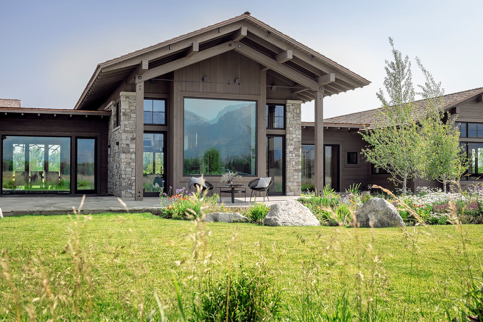 Inspiration for a rustic brown mixed siding gable roof remodel with a shingle roof