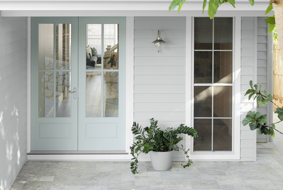 Mid-sized beach style entryway in Sunshine Coast with grey walls, ceramic floors, a double front door, a green front door and grey floor.