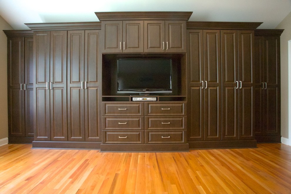 Inspiration for a large traditional master bedroom in Newark with medium hardwood floors, beige walls and brown floor.