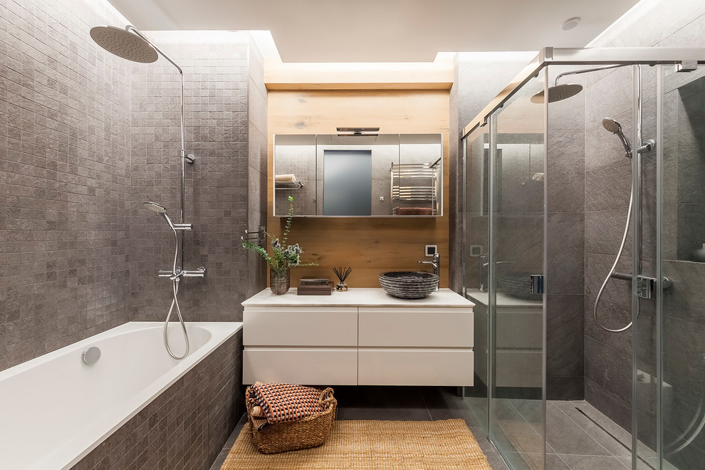 Design ideas for a mid-sized contemporary master bathroom in Other with flat-panel cabinets, white cabinets, gray tile, ceramic tile, ceramic floors, marble benchtops, grey floor, a sliding shower screen, white benchtops, an alcove tub, a corner shower and a vessel sink.