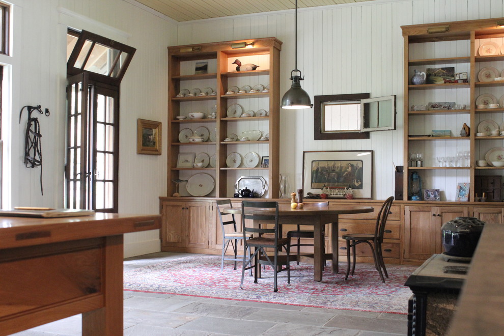 Inspiration for a large country kitchen/dining combo in New York with white walls and slate floors.