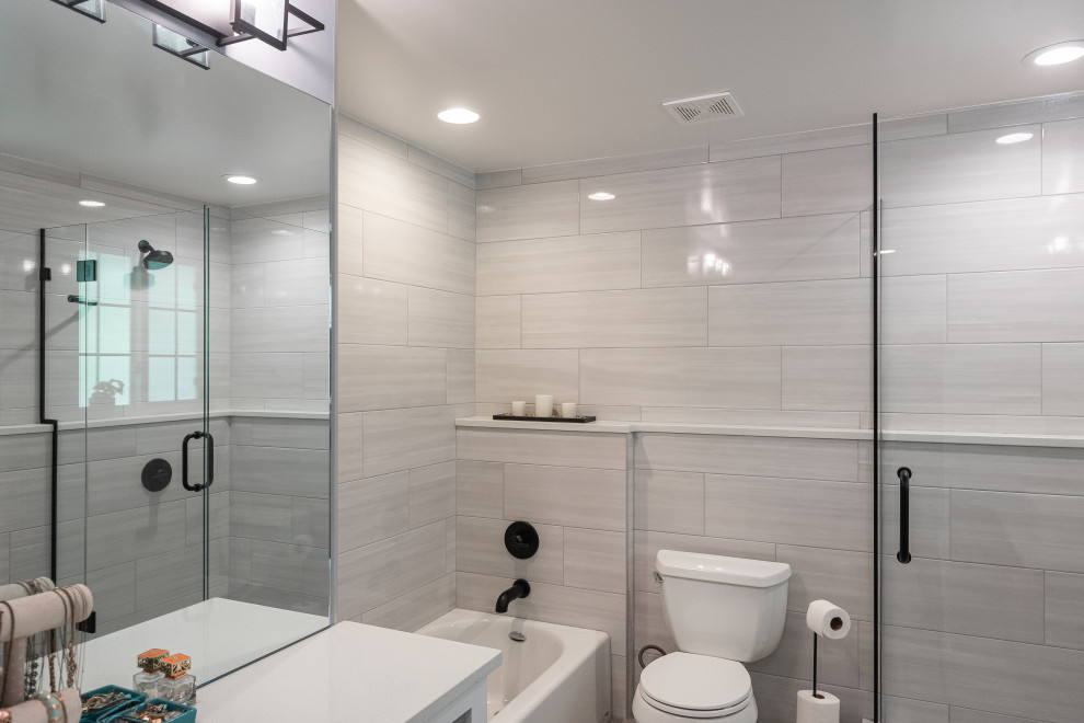 Mid-sized transitional master bathroom in Denver with open cabinets, medium wood cabinets, an alcove tub, a corner shower, a one-piece toilet, gray tile, porcelain tile, grey walls, porcelain floors, a vessel sink, engineered quartz benchtops, grey floor, white benchtops, a niche, a single vanity and a freestanding vanity.