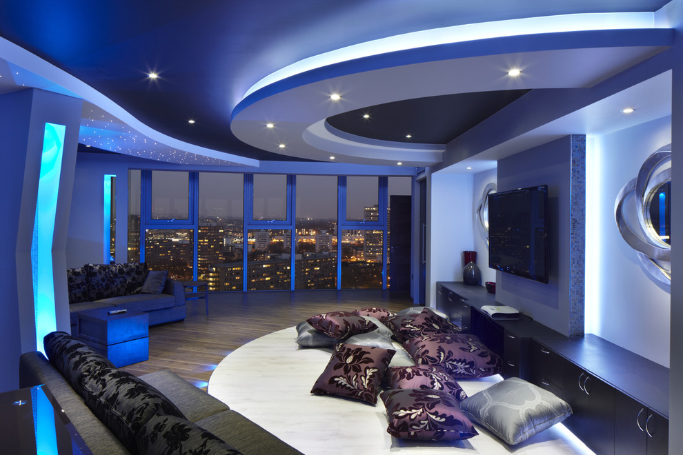 This is an example of a contemporary home theatre in London with a wall-mounted tv.