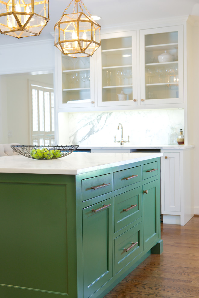 Inspiration for a mid-sized timeless galley open concept kitchen remodel in Atlanta with glass-front cabinets, white cabinets, granite countertops, white backsplash and an island