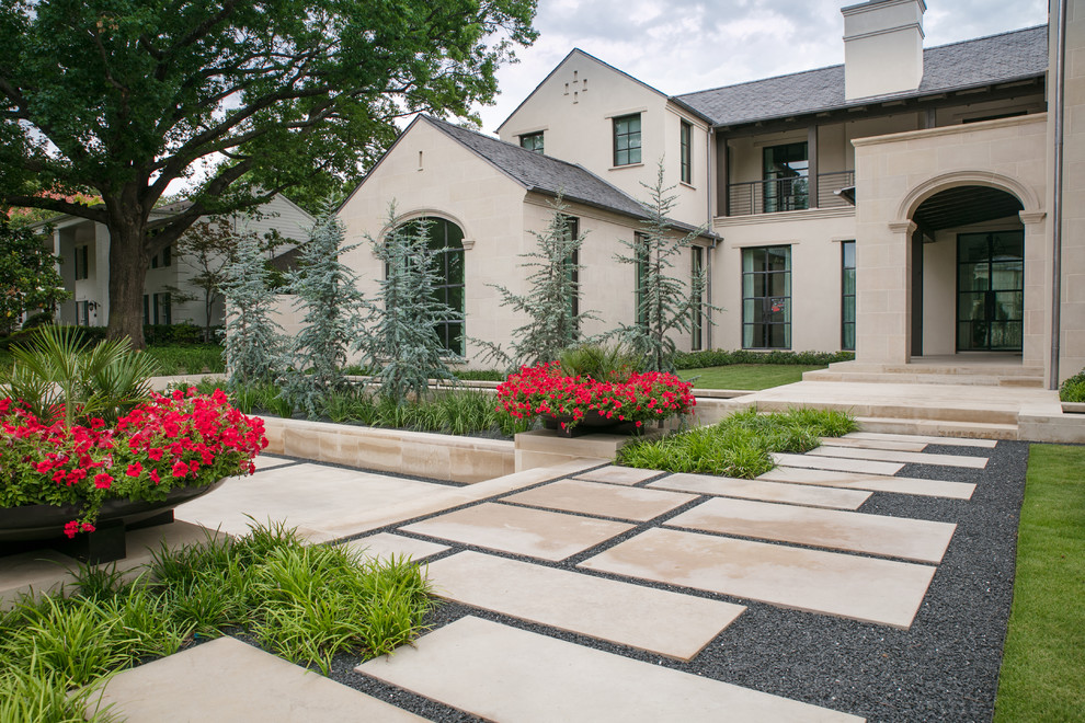 Photo of a mid-sized contemporary front yard full sun formal garden for spring in Dallas with a garden path and natural stone pavers.