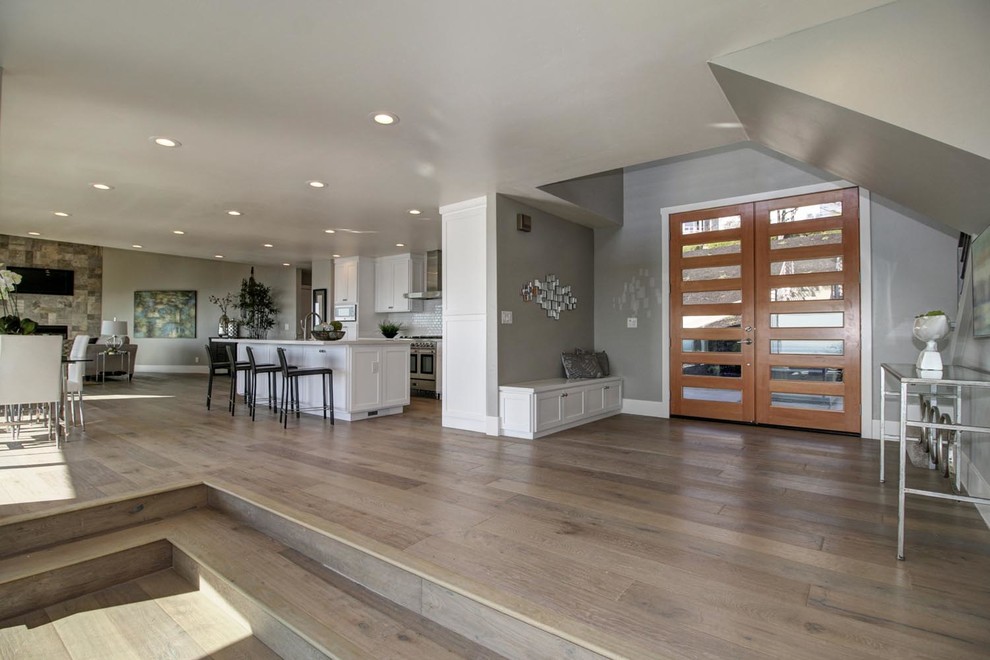Inspiration for a large contemporary foyer in Sacramento with grey walls, medium hardwood floors, a double front door and a medium wood front door.