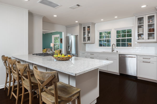Inspiration for a large transitional l-shaped dark wood floor open concept kitchen remodel with an undermount sink, shaker cabinets, gray cabinets, quartz countertops, white backsplash, subway tile backsplash, stainless steel appliances and a peninsula