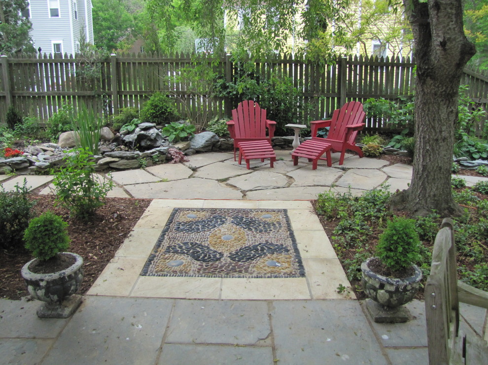 This is an example of a mid-sized traditional backyard patio in DC Metro with a water feature, concrete pavers and a pergola.