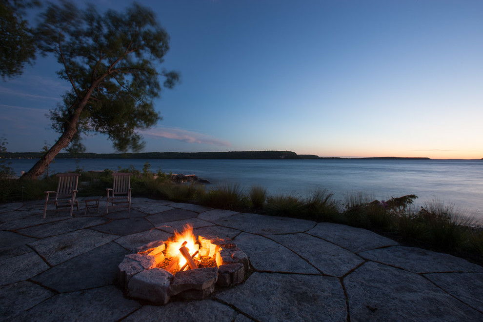 Inspiration for a large rustic backyard stone full sun patio remodel for summer