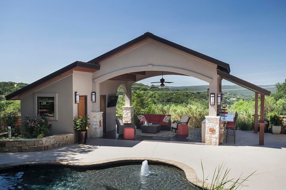 Photo of a large contemporary backyard patio in Austin with an outdoor kitchen and an awning.