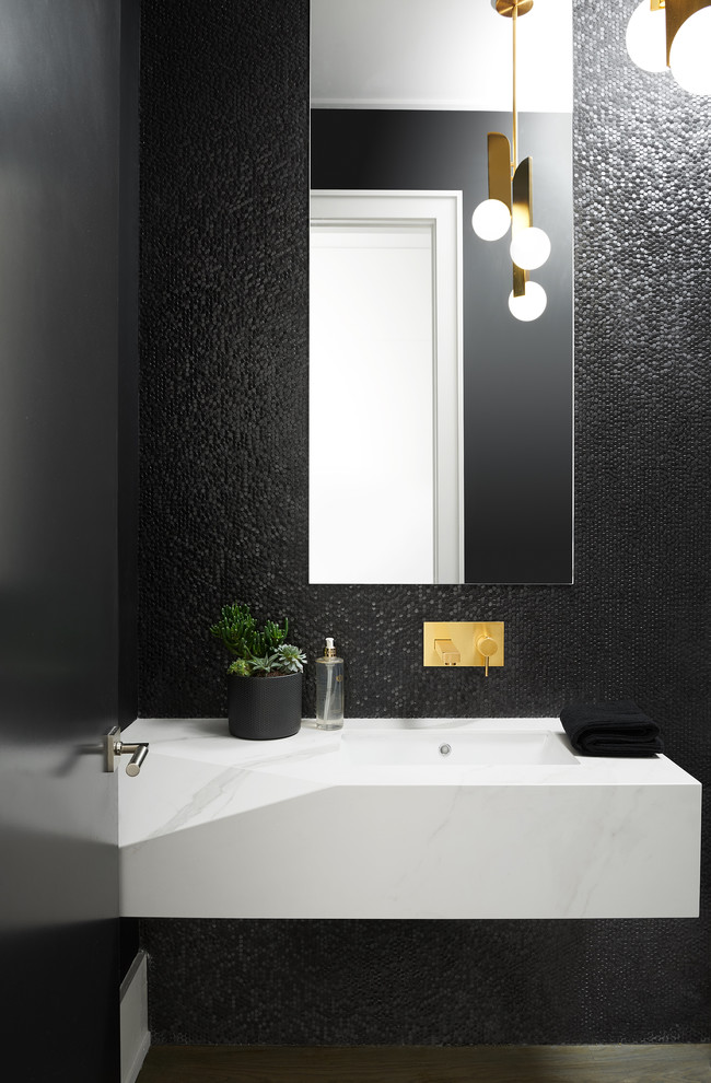 Photo of a small contemporary powder room in Toronto with black tile, black walls, white benchtops and an integrated sink.