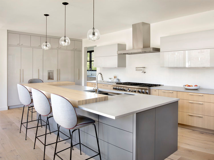 Mid-sized contemporary l-shaped separate kitchen in Denver with an undermount sink, flat-panel cabinets, white cabinets, granite benchtops, white splashback, stainless steel appliances, medium hardwood floors and with island.