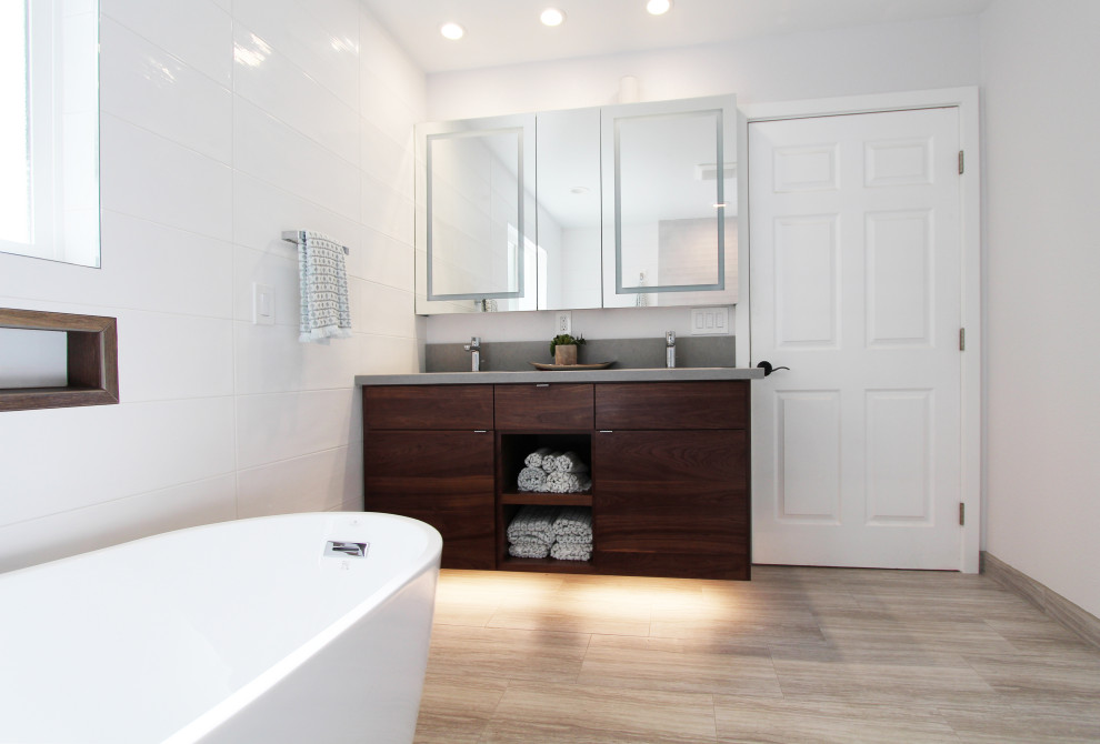 Inspiration for a large transitional master white tile and ceramic tile porcelain tile, gray floor and double-sink freestanding bathtub remodel with flat-panel cabinets, dark wood cabinets, a one-piece toilet, white walls, an undermount sink, quartz countertops, gray countertops, a niche and a floating vanity