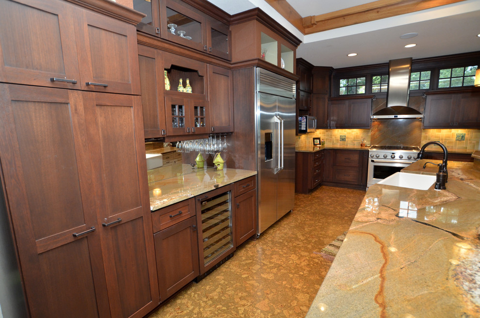 Eat-in kitchen - huge transitional cork floor eat-in kitchen idea in Milwaukee with a farmhouse sink, flat-panel cabinets, medium tone wood cabinets, granite countertops, stone tile backsplash, stainless steel appliances and an island