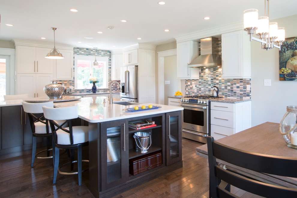 Inspiration for a large contemporary u-shaped dark wood floor and brown floor eat-in kitchen remodel with an undermount sink, recessed-panel cabinets, dark wood cabinets, quartz countertops, multicolored backsplash, matchstick tile backsplash, stainless steel appliances, two islands and white countertops