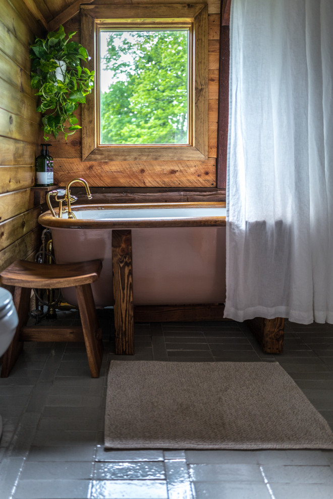 Design ideas for a mid-sized country kids bathroom in New York with a claw-foot tub, a shower/bathtub combo, white walls, brick floors, grey floor, a shower curtain, a single vanity, a floating vanity, vaulted and wood walls.