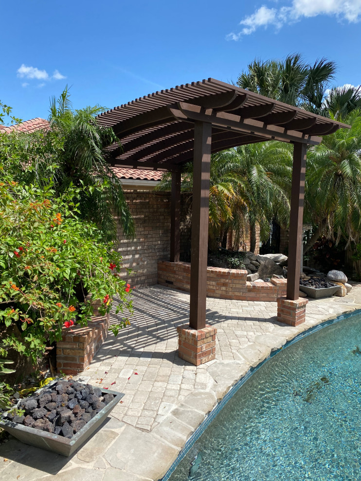 Inspiration for a mid-sized contemporary backyard brick pool remodel