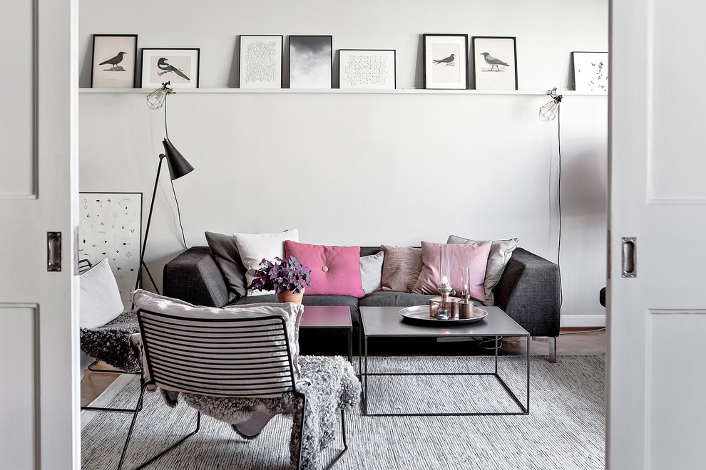 This is an example of a mid-sized scandinavian enclosed living room in Malmo with white walls.